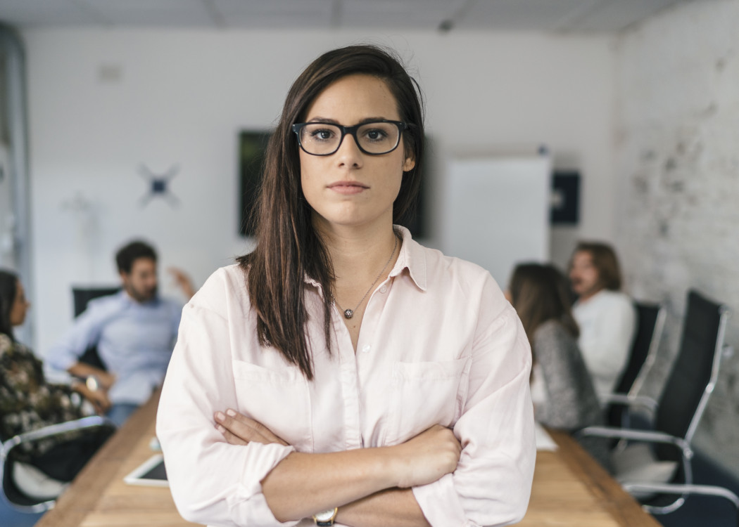 confident-woman-stands-in-modern-office